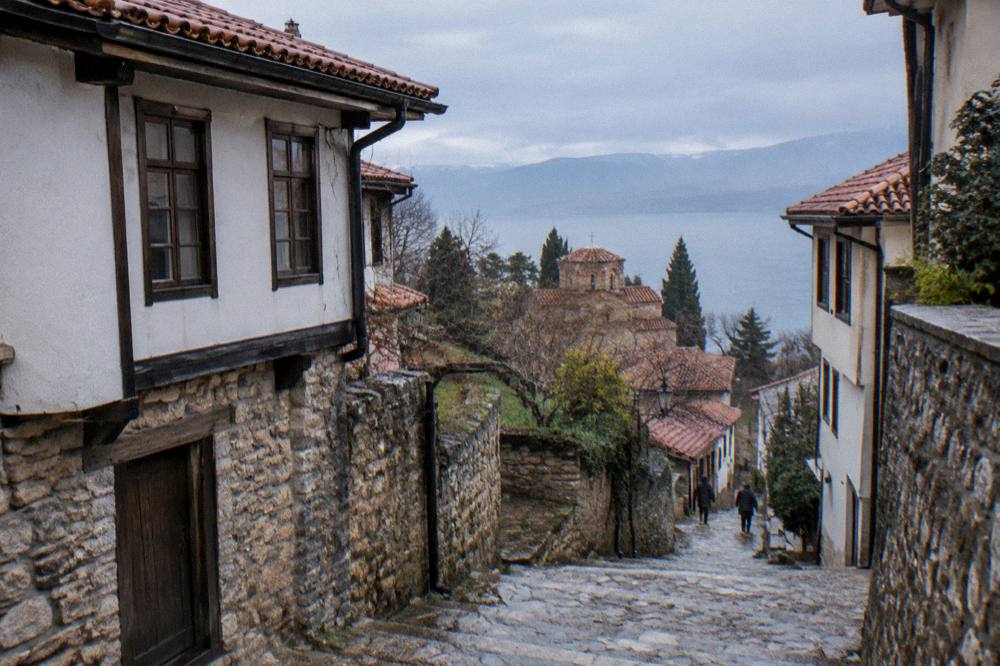 Stone steps climbing between old houses toward Samuel's Fortress in Ohrid