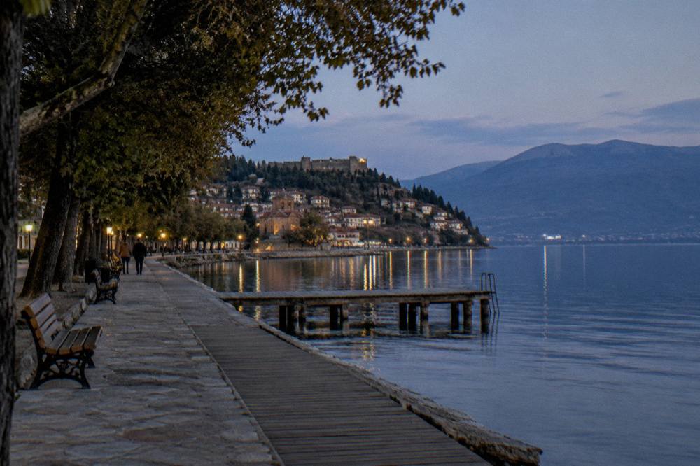 A quiet evening on the Ohrid lakeside promenade with lights reflecting on the water