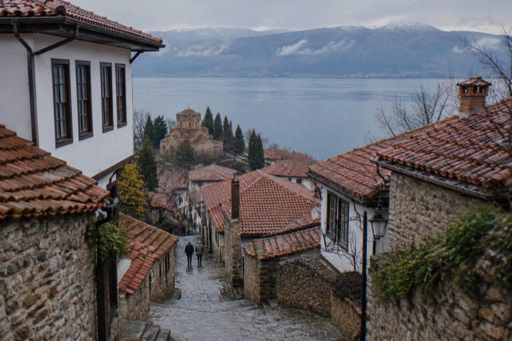A panoramic view over the red roofs of Ohrid old town and the wide blue lake beyond