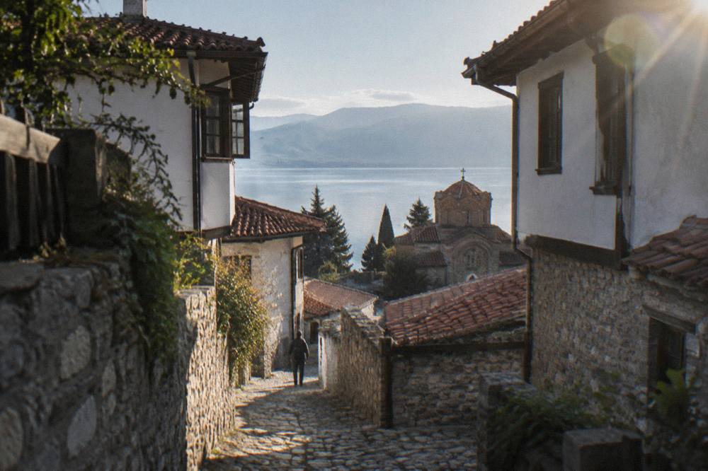 A quiet morning trail signposted at the edge of Ohrid with the lake calm in the background