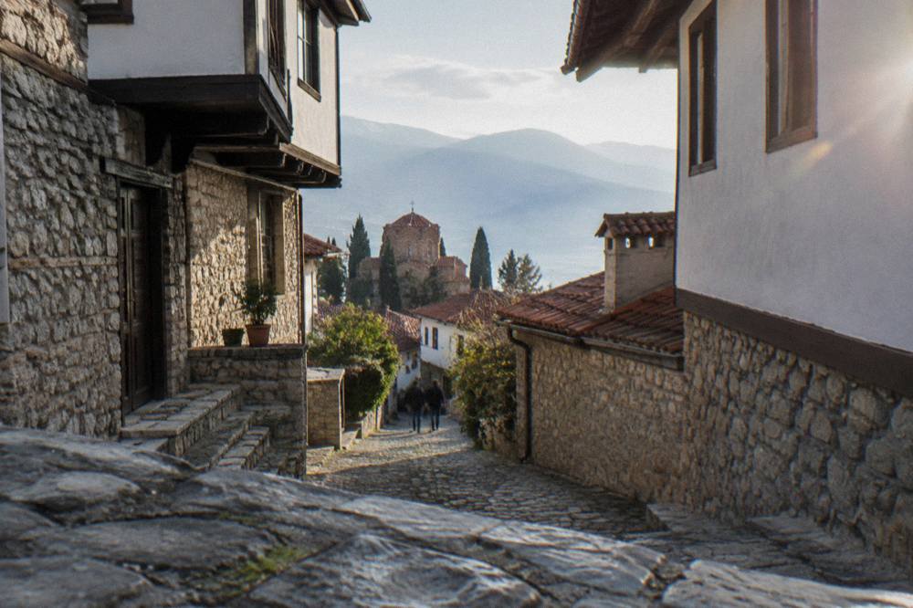 Cobblestone lane in the old town with stone house walls and worn steps