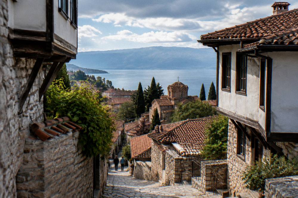 Panorama of Ohrid's old town churches and red roofs above the blue lake