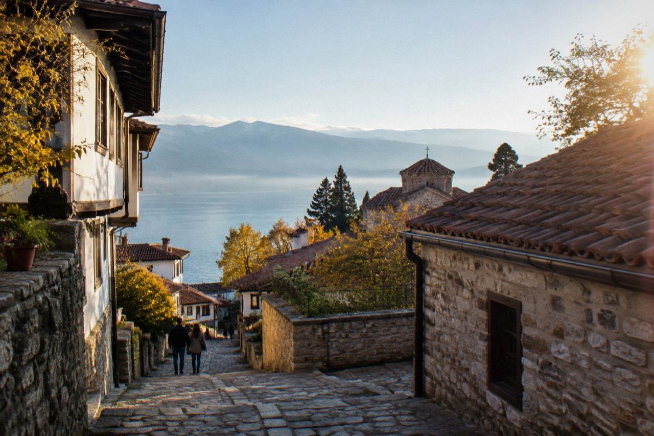 The old town of Ohrid above Lake Ohrid in autumn light, with the lake stretching to distant hills