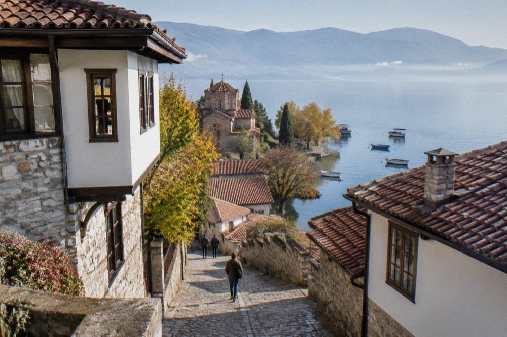 Boats moored on Lake Ohrid beside the old town quay in soft autumn light