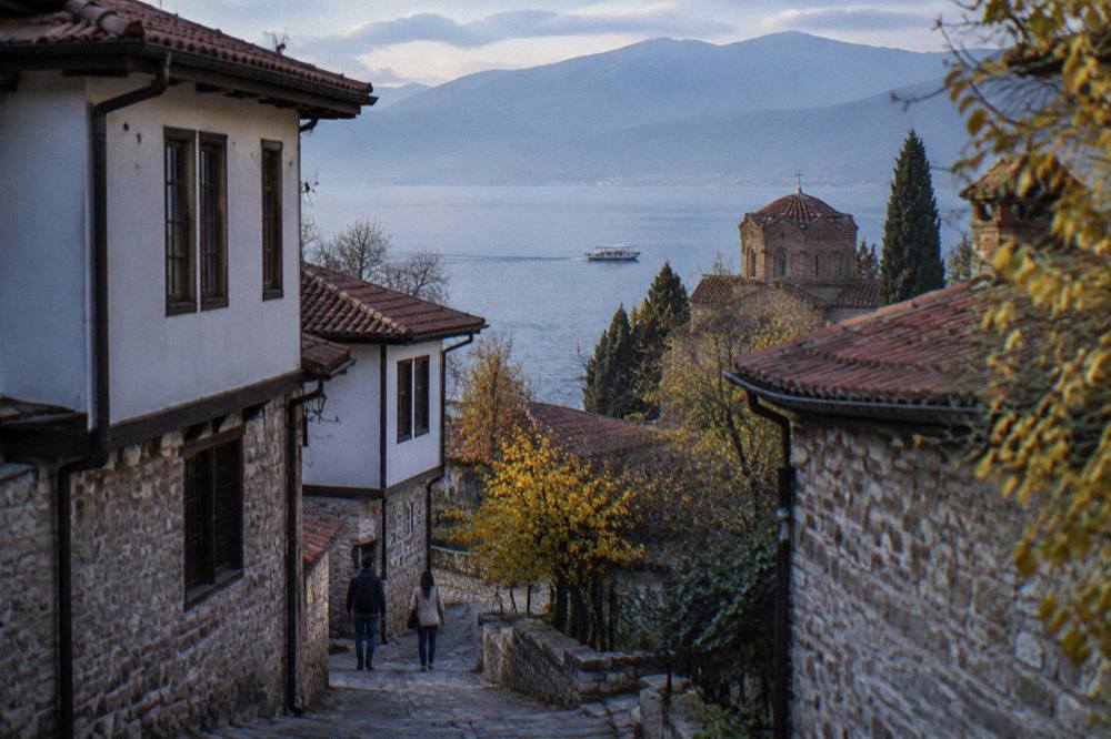 A boat crossing Lake Ohrid towards St Naum in calm autumn weather
