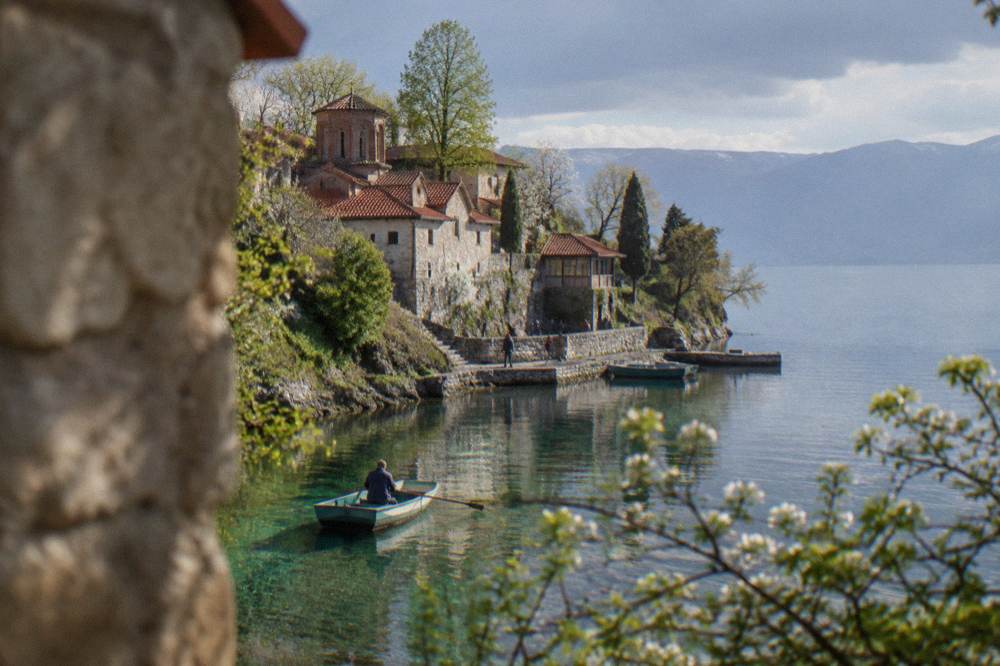 A small boat on clear green water near the Crn Drim springs at St Naum