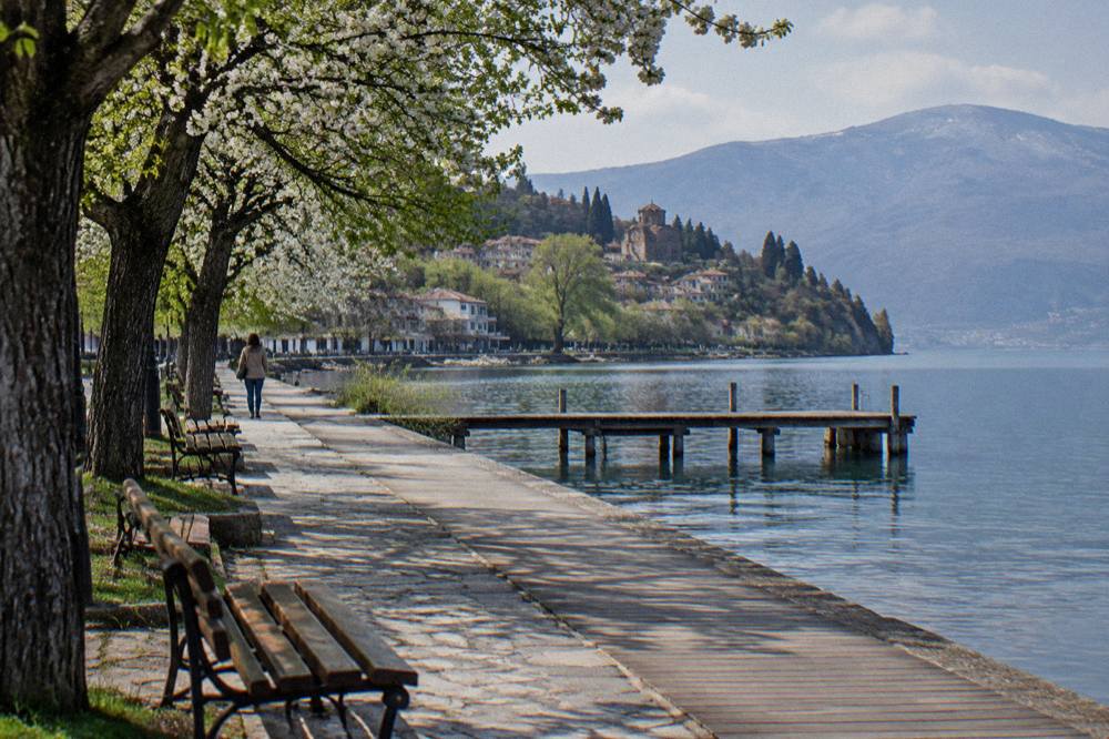 A quiet lakeside promenade in Ohrid with empty benches in spring
