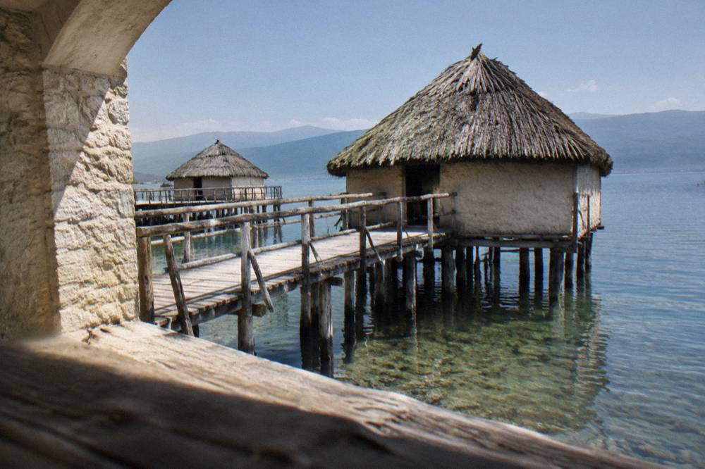 A reconstructed pile dwelling on the water at the Bay of Bones museum near Peshtani