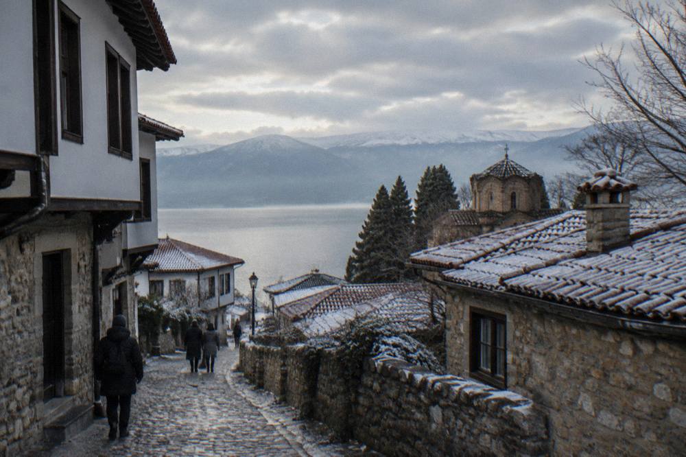 Frost-covered rooftops of Ohrid old town at dawn with mist over the lake