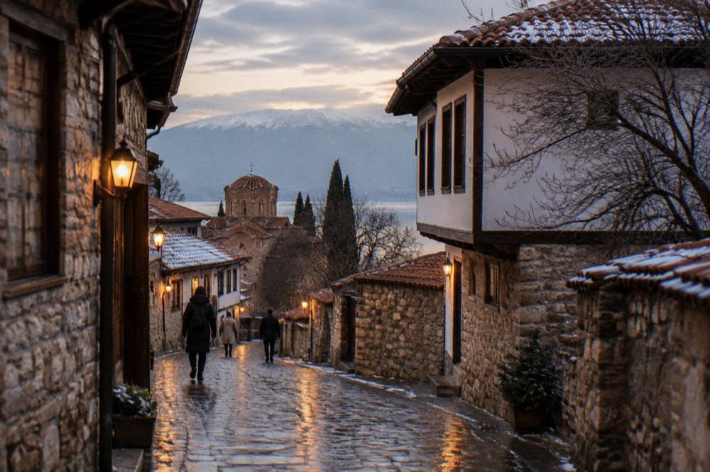 Evening lights reflecting on wet stone paving in Ohrid old town in winter