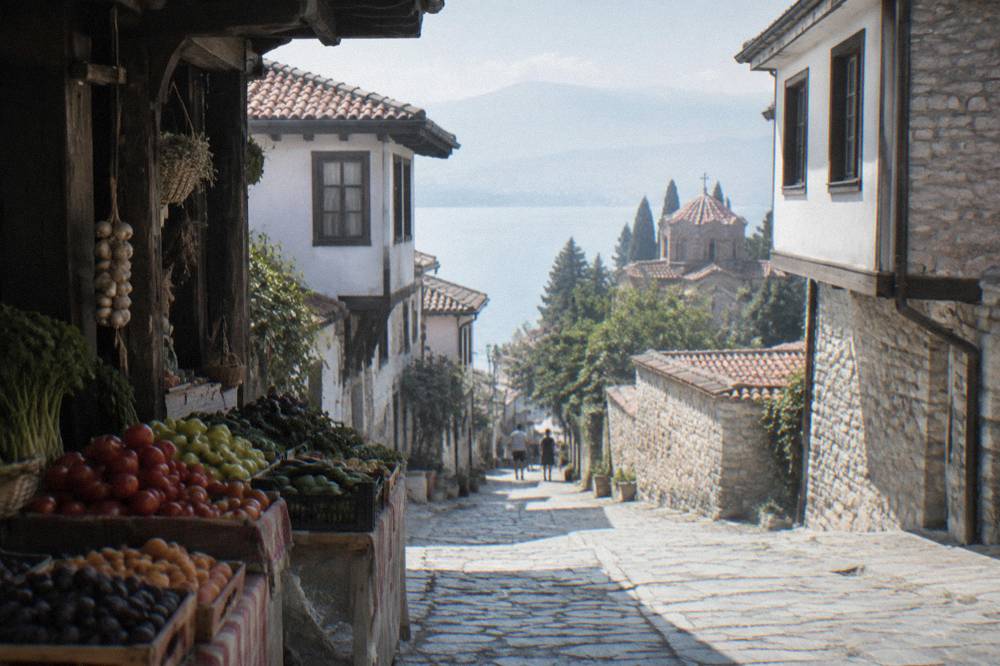 A market stall in Ohrid with fresh produce and handwritten price signs