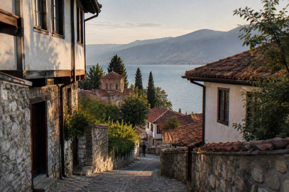 An evening view over Ohrid rooftops with the lake and hills beyond
