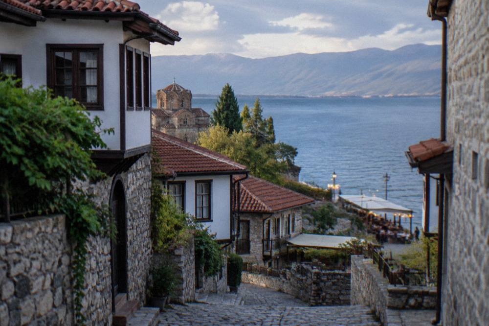 Evening lights along the Ohrid lakefront quay with tables set outside