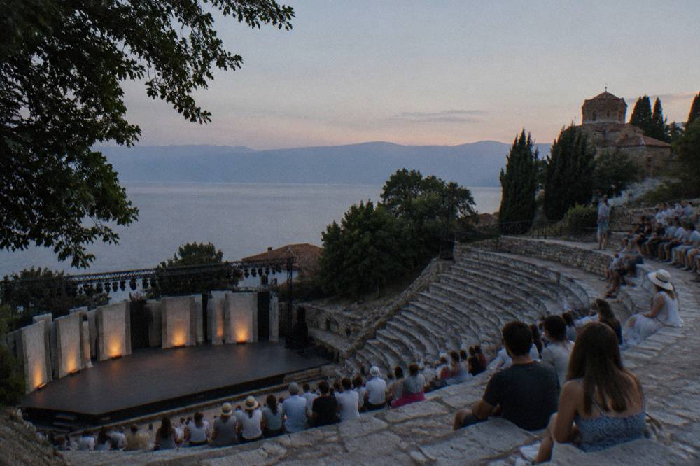 Open-air stone theatre seats at dusk in Ohrid before a performance