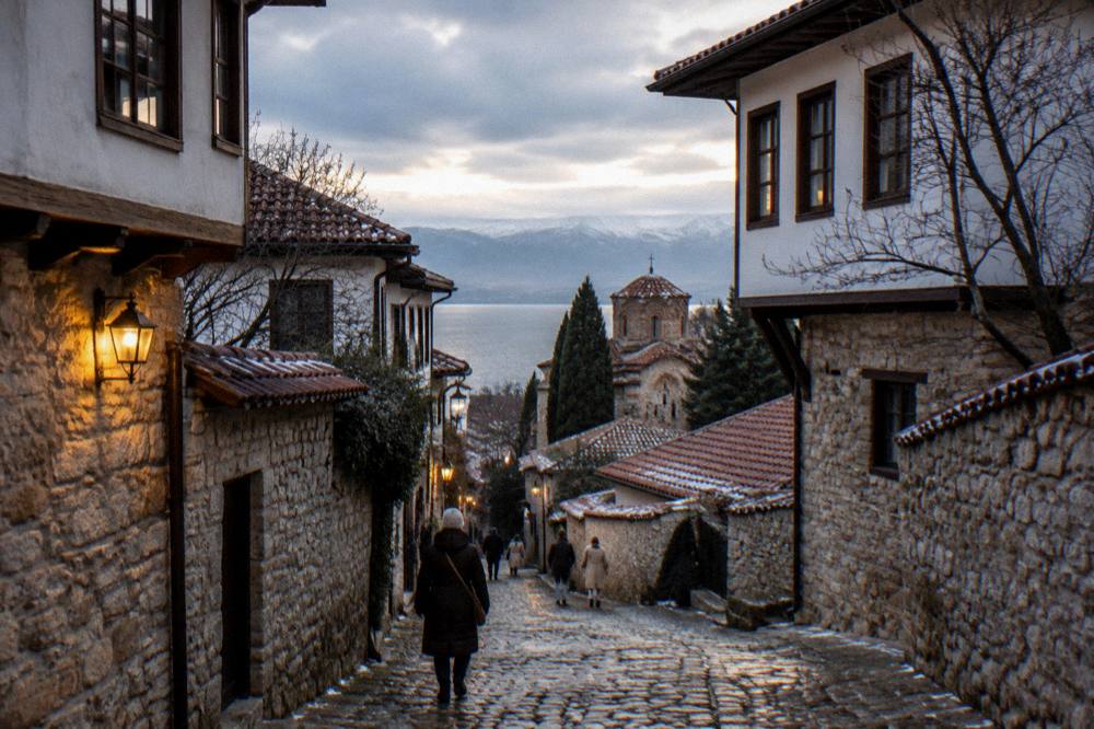 A lit stone lane in the Ohrid old town on a winter evening