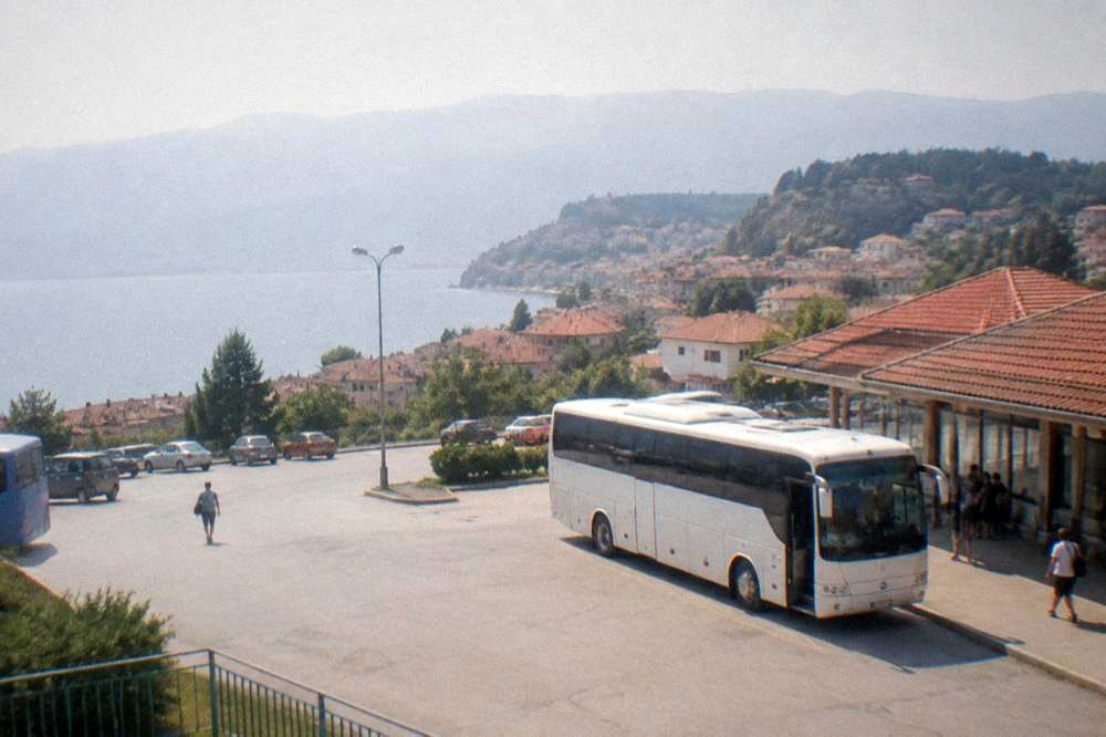 A bus parked at Ohrid bus station with the town behind