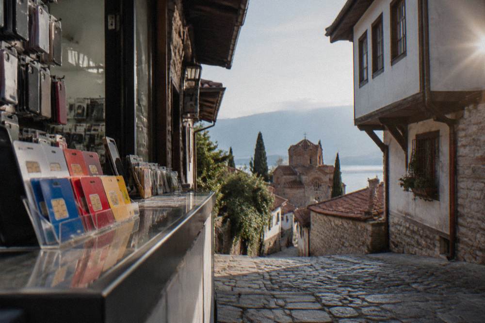 A phone shop counter in a Balkan town with prepaid SIM displays