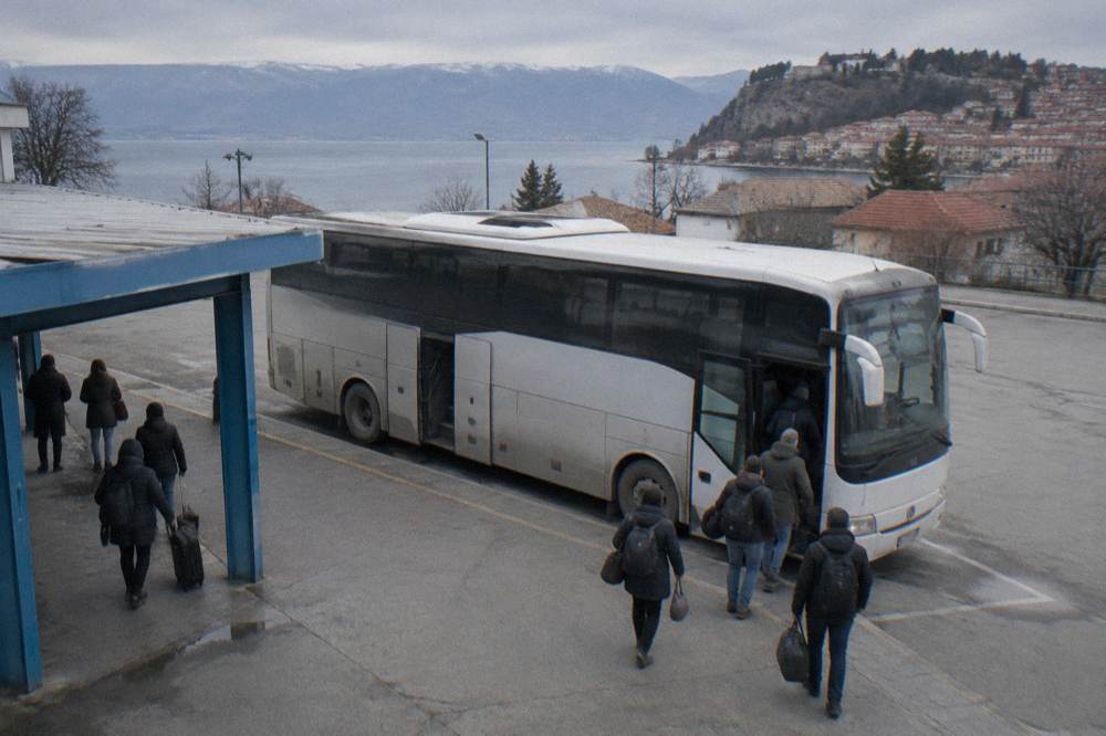 An intercity bus parked at the Ohrid bus station with passengers boarding
