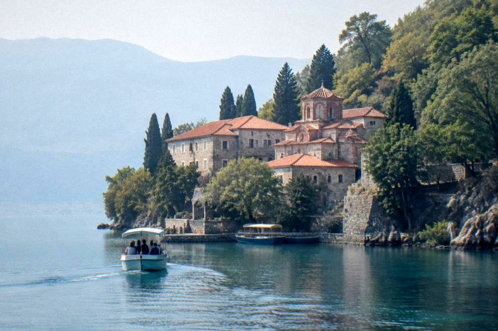 A small boat approaching the St Naum monastery jetty on Lake Ohrid
