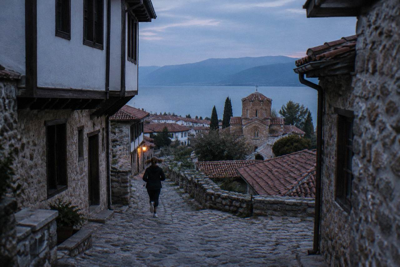 Stone church above the shore of Lake Ohrid with the old town below
