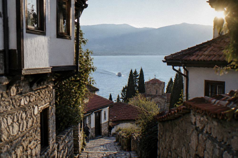 Boat on blue water heading toward the southern end of Lake Ohrid