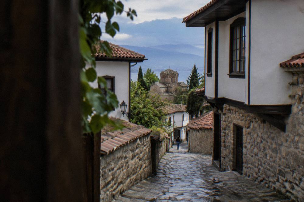Narrow stone lane in Ohrid old town with whitewashed walls