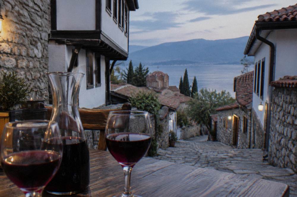 A carafe of red wine and two glasses on a restaurant table in Ohrid old town