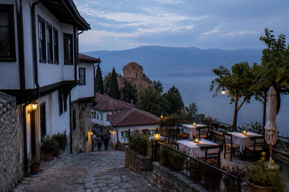 A lakeside terrace in Ohrid with tables set for the evening above the water