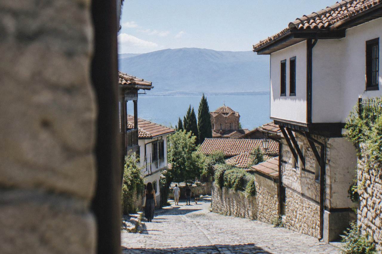A road winding through hills toward the blue water of Lake Ohrid