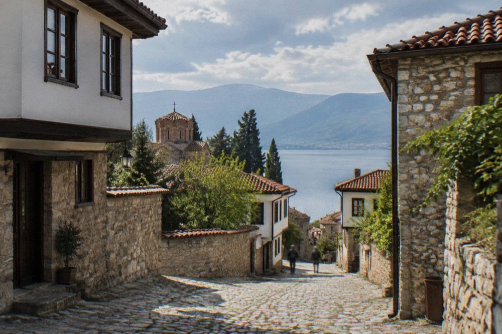 A long straight road crossing a green valley in western North Macedonia