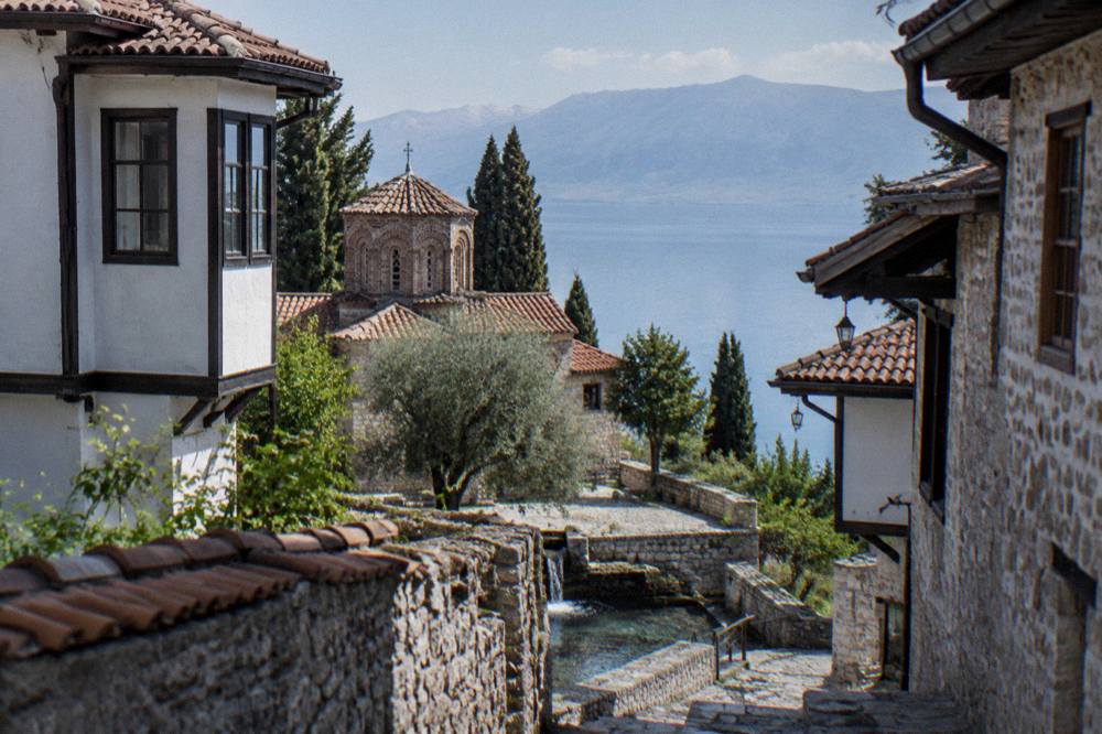 A monastery courtyard with a stone church beside springs of clear water