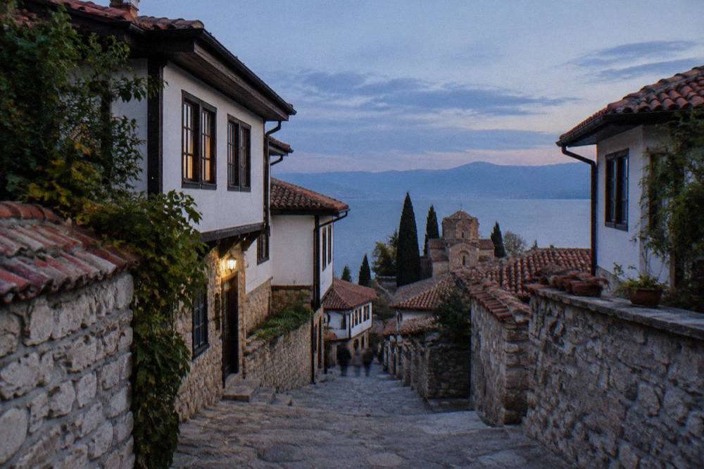 A narrow stone lane with old houses on both sides climbing a hillside in steps