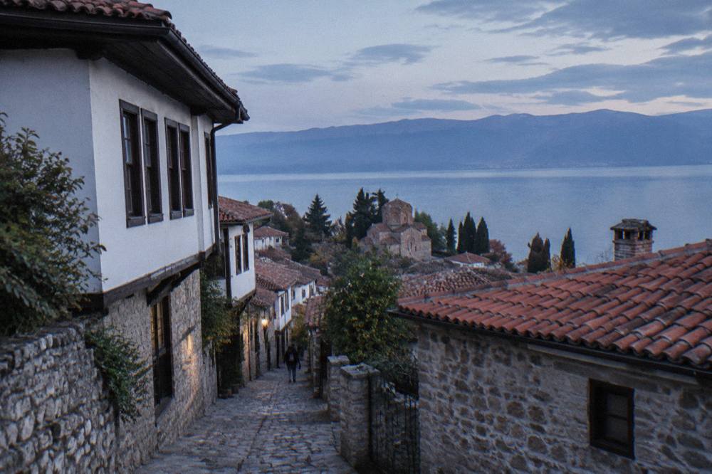Red-tiled roofs of Ohrid old town seen from the fortress hill with the blue lake beyond