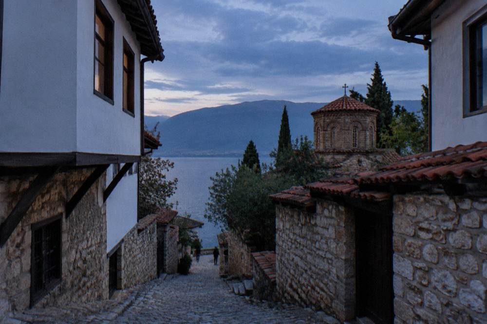 A quiet pebble beach on the eastern shore of Lake Ohrid with clear shallow water
