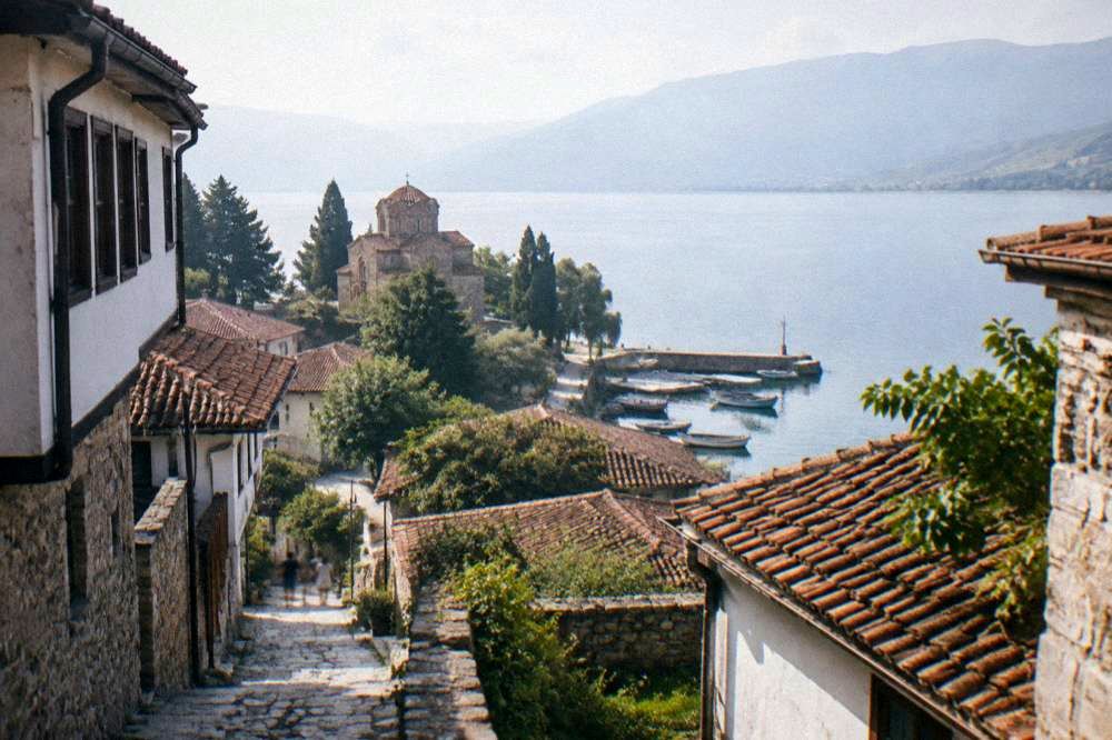 Traditional fishing boats moored beside a small harbour on Lake Ohrid at dawn