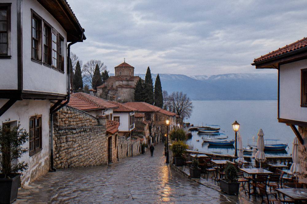 Evening light on the Ohrid quay with cafe tables and boats along the water