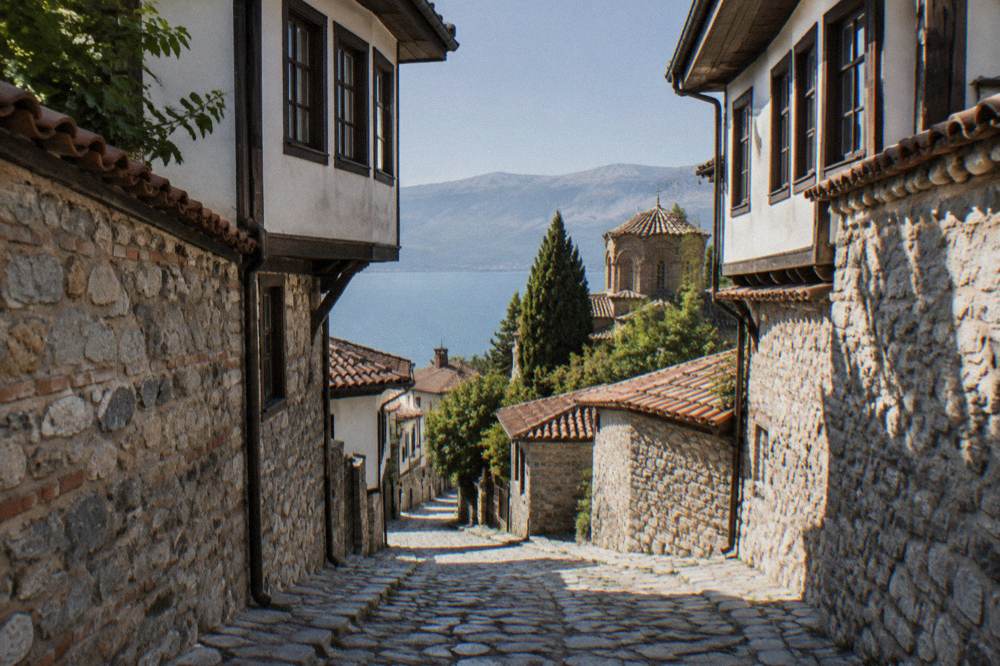 An empty stone lane with old house walls in Ohrid old town in late afternoon light