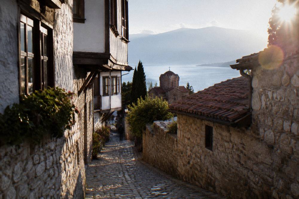 Narrow cobbled lane in Ohrid old town with whitewashed stone walls