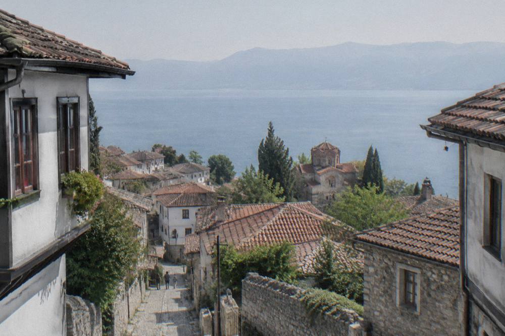 View across the tiled roofs of Ohrid toward the blue expanse of Lake Ohrid
