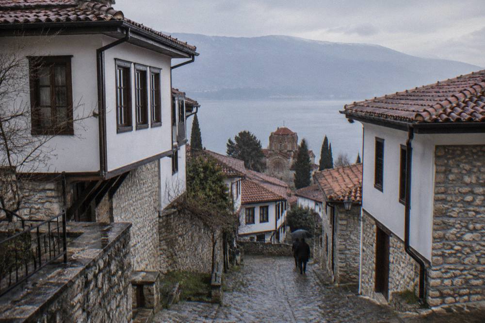 A narrow stone lane climbing between old houses in Ohrid old town