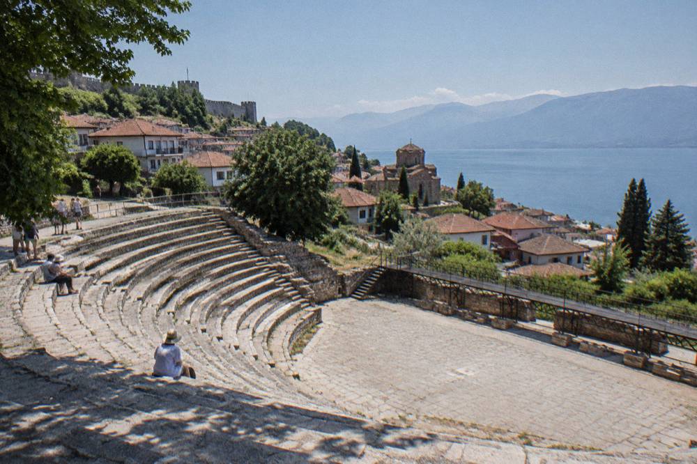 The stone seats of the Ancient Theatre in Ohrid with the town behind