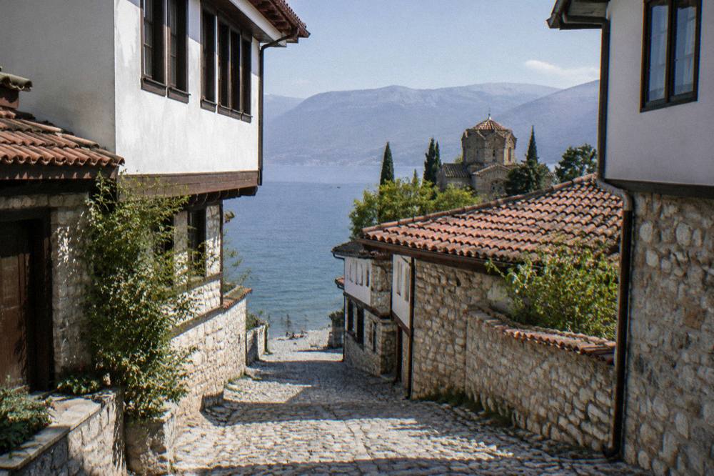 A pebble beach on the Lake Ohrid shore with clear shallow water