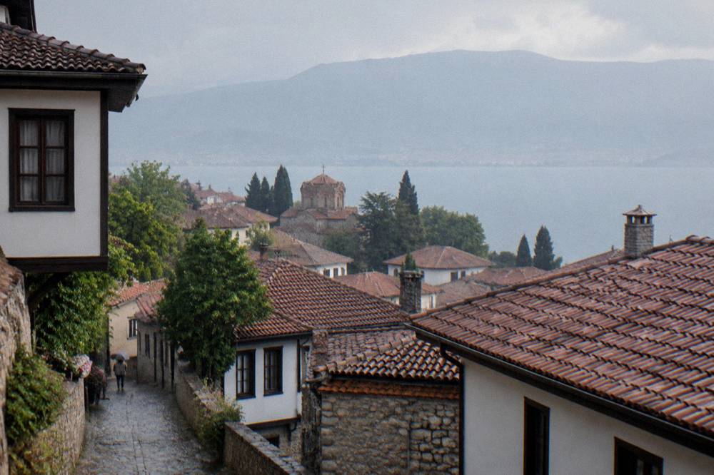 Old town rooftops of Ohrid seen through light rain from a high vantage point
