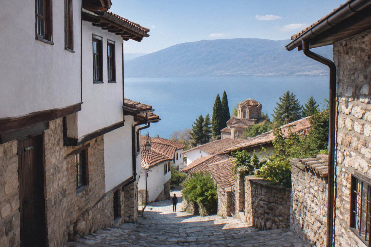 The red-tiled roofs of Ohrid old town descending toward the blue water of Lake Ohrid