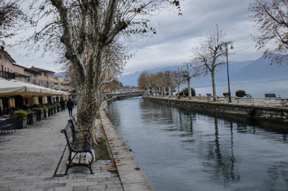 The Black Drim river flowing through Struga beside a tree-lined quay