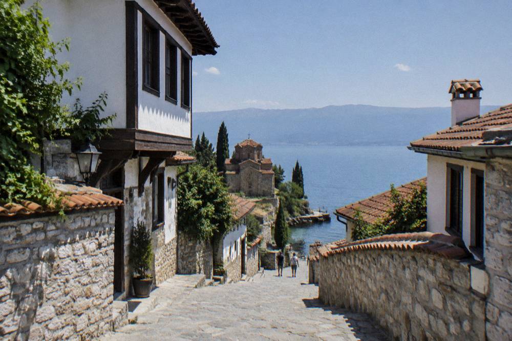 A small monastery church above a boat jetty at the springs on Lake Ohrid's south shore