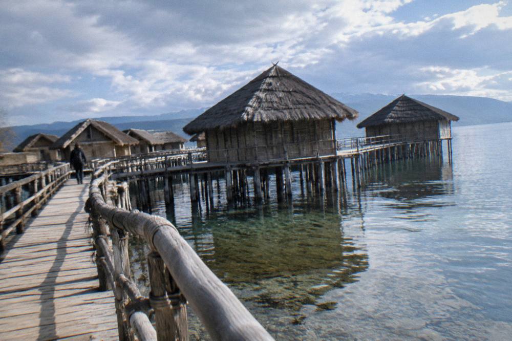 A reconstructed pile-dwelling museum standing on stilts above Lake Ohrid