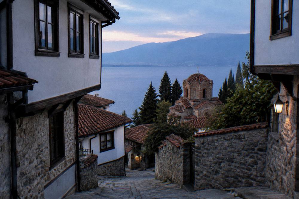 Church dome and lake water seen from a high stone terrace in Ohrid