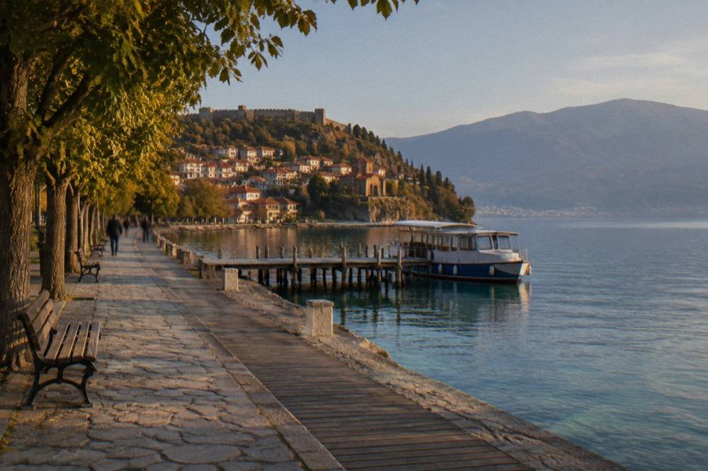 A passenger boat moored at a wooden jetty on clear green lake water